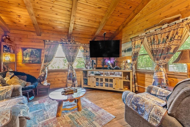 living area with vaulted ceiling with beams, hardwood / wood-style floors, wood walls, and wooden ceiling