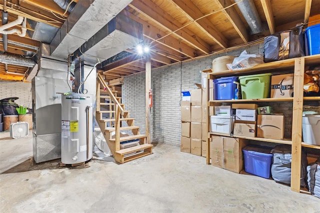 unfinished below grade area with water heater and brick wall