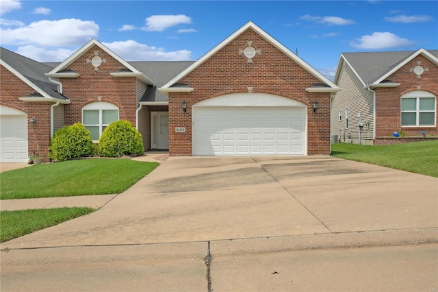 view of front of property with a front yard and a garage