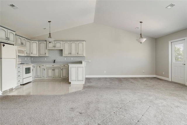 kitchen featuring pendant lighting, white appliances, lofted ceiling, and backsplash