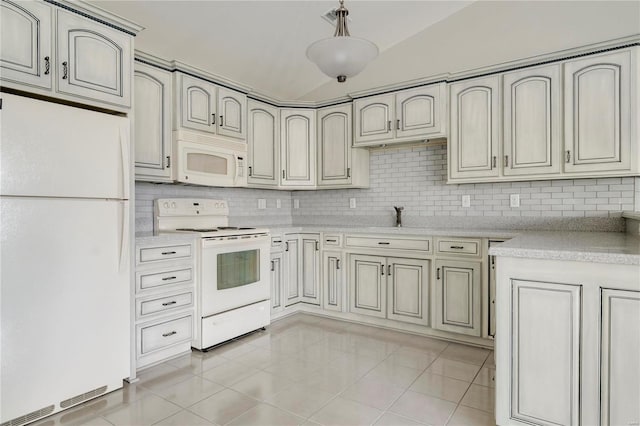 kitchen featuring white appliances, decorative light fixtures, vaulted ceiling, and light tile patterned flooring