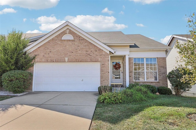 view of front of home featuring a garage and a front lawn