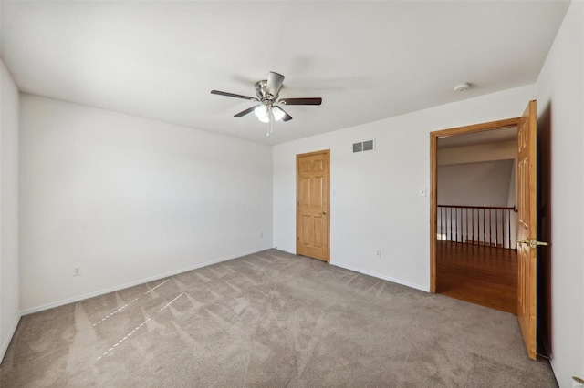 unfurnished bedroom featuring light carpet, a closet, and ceiling fan