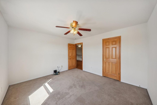 unfurnished bedroom with ceiling fan and carpet floors