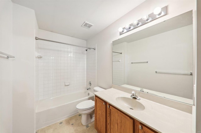 full bathroom featuring tiled shower / bath, vanity, and toilet