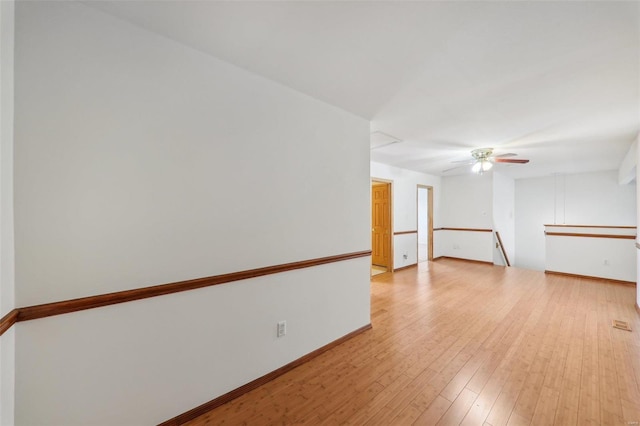 empty room with ceiling fan and light wood-type flooring