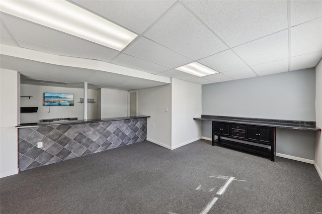 basement with carpet floors and a paneled ceiling