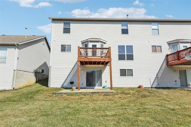 back of property with a patio, a lawn, and a balcony