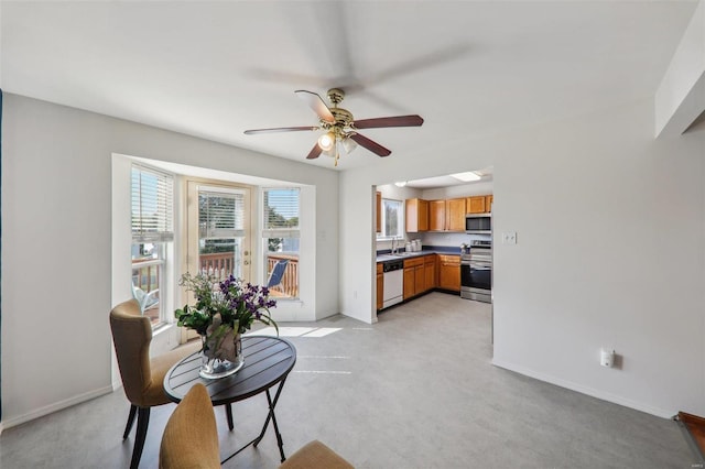 interior space with ceiling fan and sink