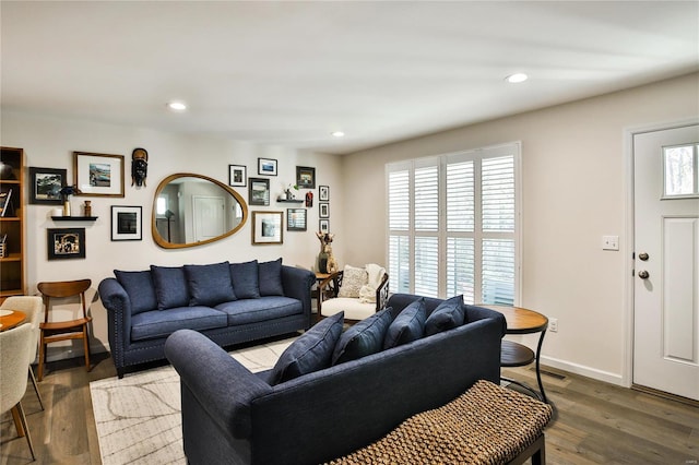 living room featuring dark hardwood / wood-style flooring and a wealth of natural light