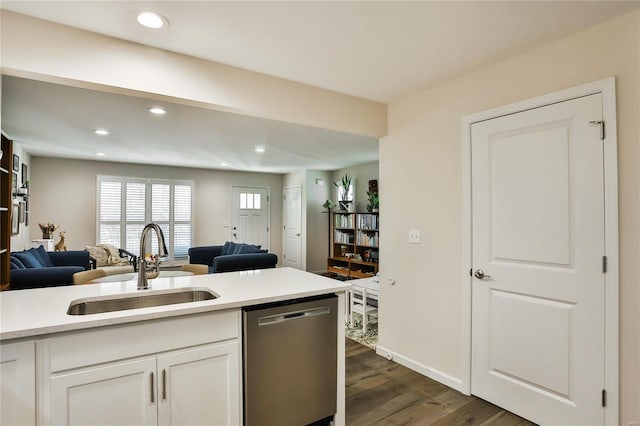 kitchen featuring sink, dishwasher, white cabinets, and dark hardwood / wood-style floors