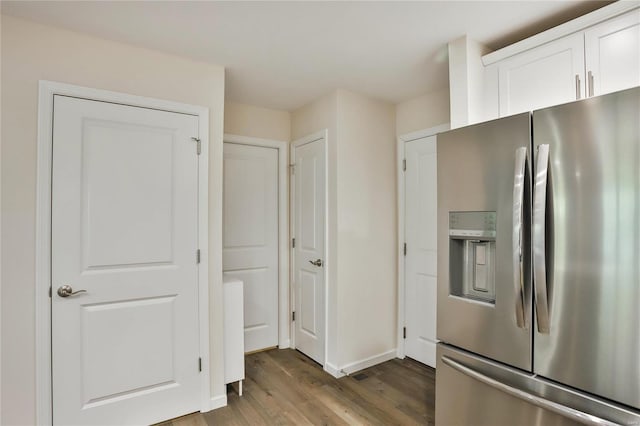 kitchen featuring hardwood / wood-style flooring, white cabinetry, and stainless steel fridge with ice dispenser