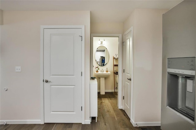 hallway with hardwood / wood-style floors