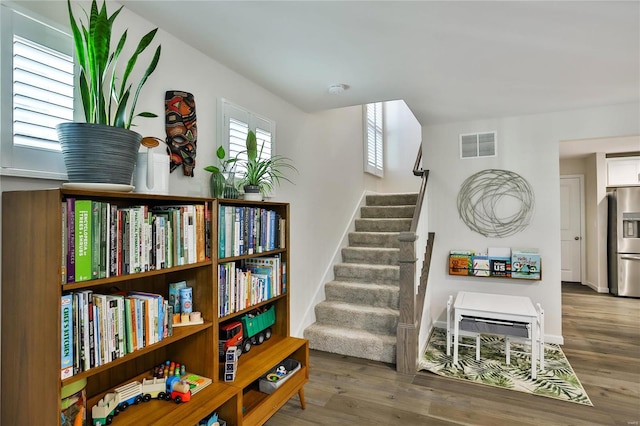 stairway with hardwood / wood-style flooring