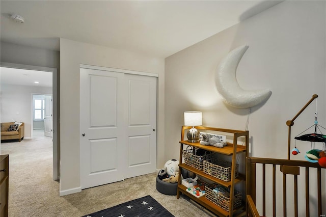 sitting room featuring light colored carpet