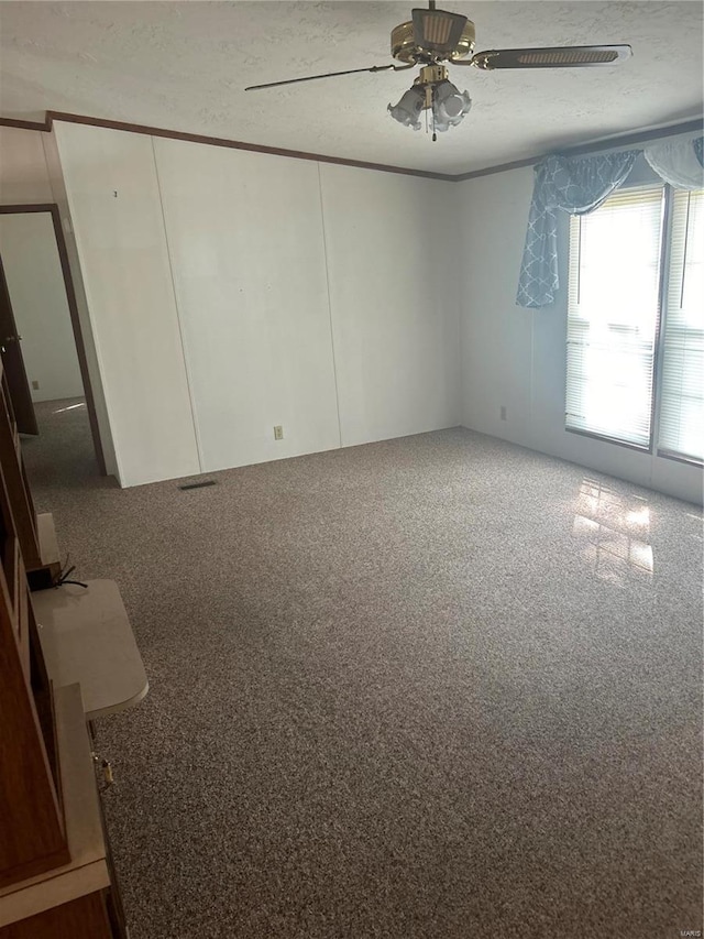 unfurnished bedroom featuring ceiling fan, a textured ceiling, and carpet floors