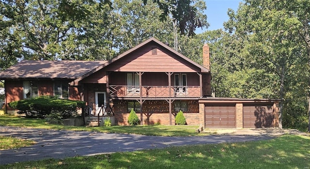 view of front of house with a garage and a front lawn