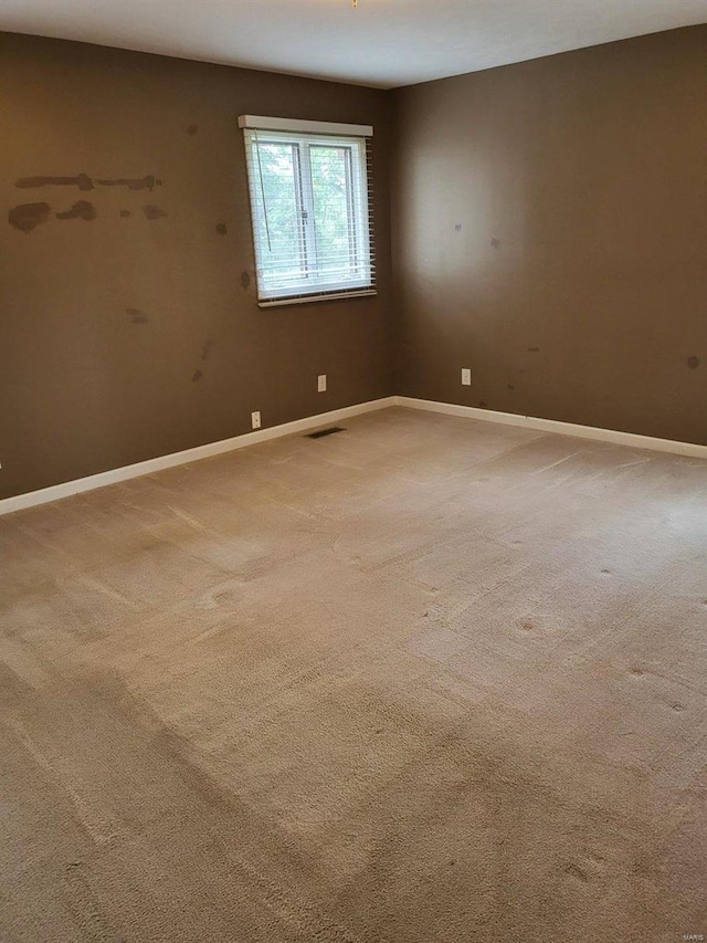 unfurnished room featuring carpet