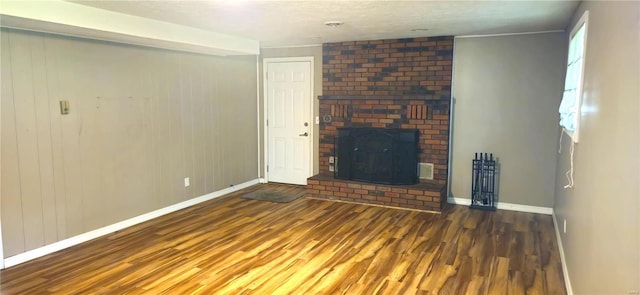 unfurnished living room featuring dark hardwood / wood-style floors and a fireplace