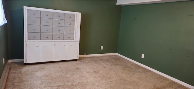 unfurnished bedroom featuring mail boxes and light colored carpet