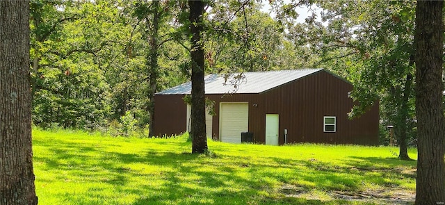 view of outbuilding featuring a yard and a garage