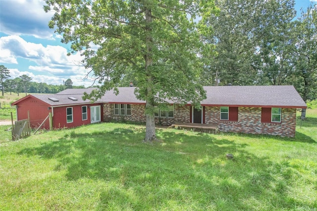 single story home with brick siding and a front yard