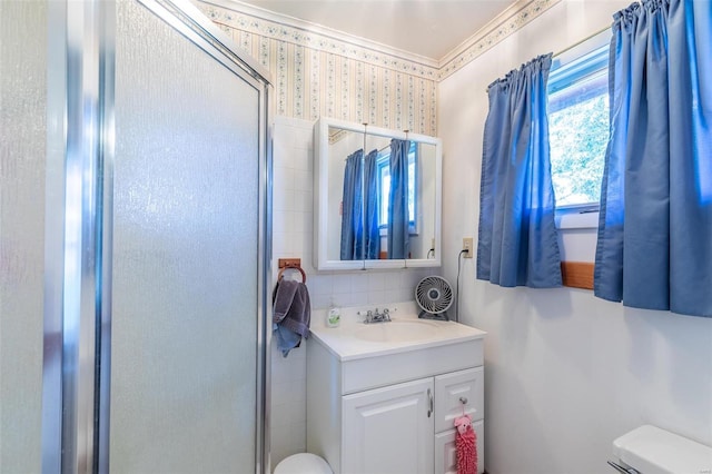 full bathroom with toilet, vanity, backsplash, a stall shower, and wallpapered walls