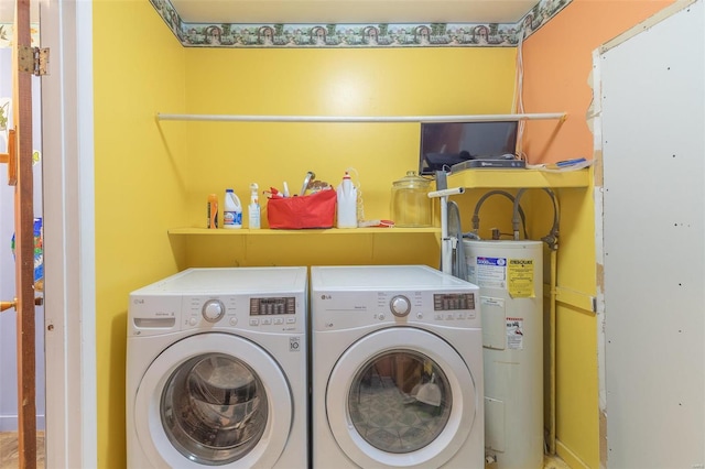 clothes washing area with water heater, laundry area, and washing machine and dryer