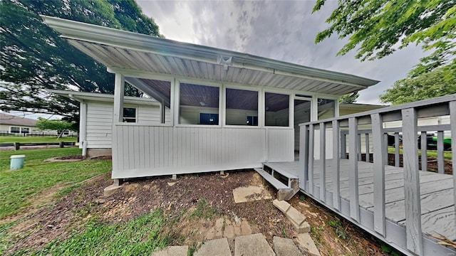 back of house with a deck and a sunroom