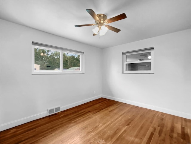 spare room with hardwood / wood-style floors and ceiling fan