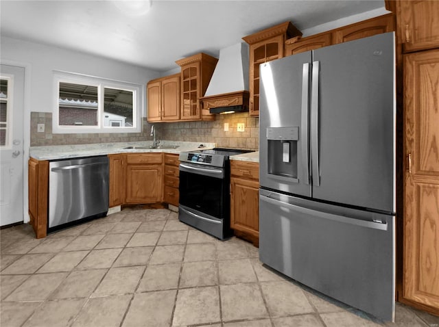 kitchen with backsplash, sink, custom range hood, and stainless steel appliances