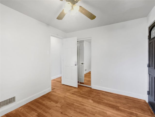 unfurnished bedroom featuring hardwood / wood-style floors and ceiling fan