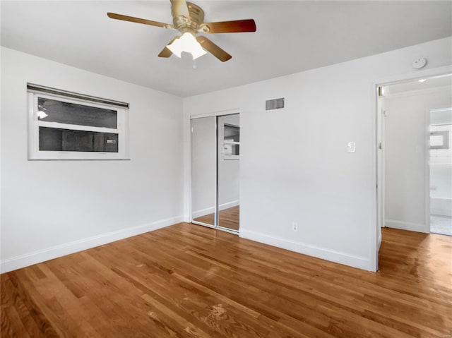 interior space with hardwood / wood-style floors, a closet, and ceiling fan