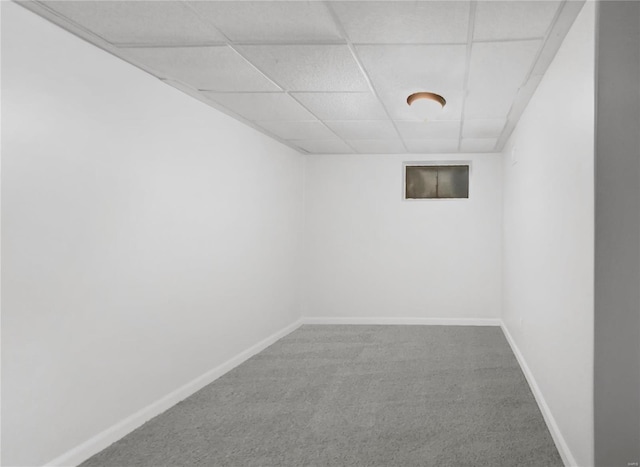 basement with carpet flooring and a paneled ceiling