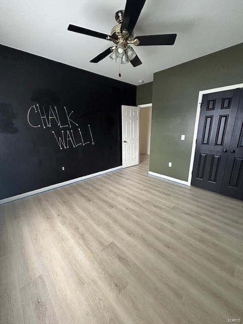 interior space featuring light hardwood / wood-style floors and ceiling fan