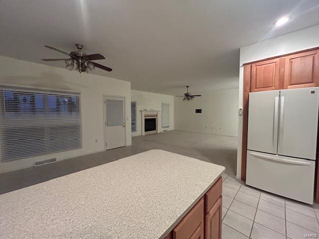 kitchen with ceiling fan, light tile patterned flooring, and white fridge