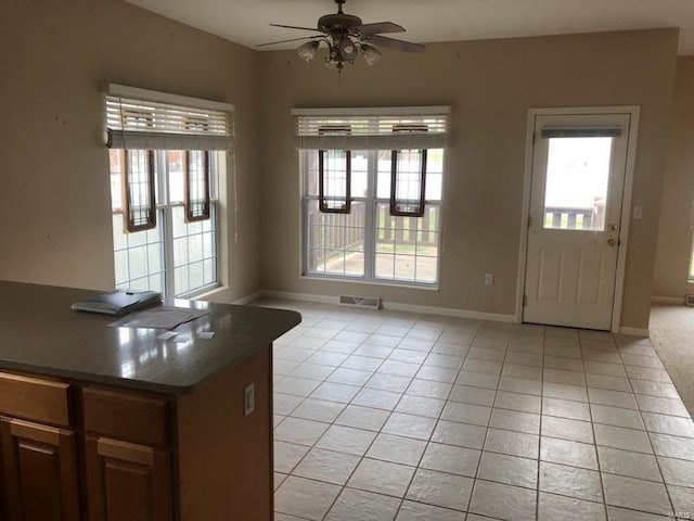 interior space featuring ceiling fan and light tile patterned floors