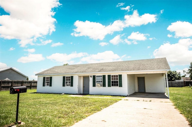 ranch-style house with a front yard and a carport