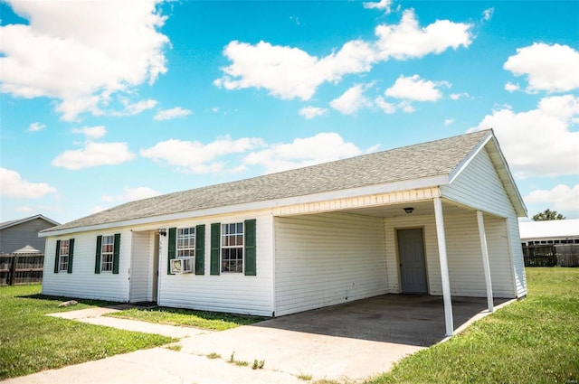 single story home featuring a front yard and a carport