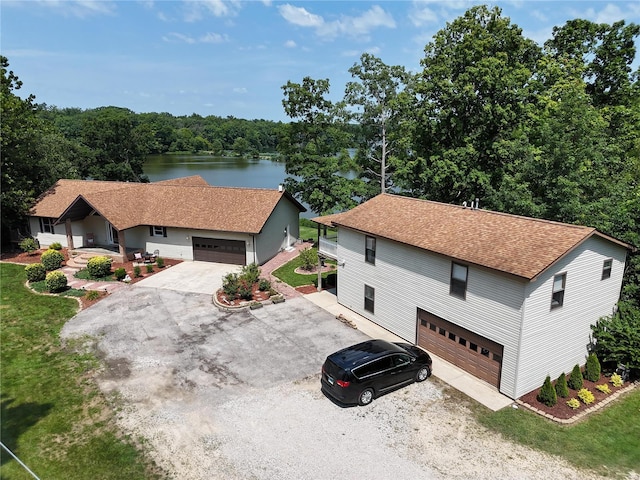 view of front of home with a water view and a garage