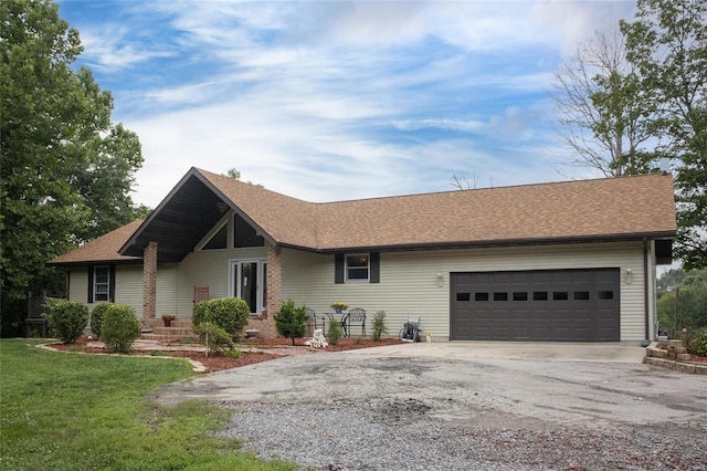 single story home featuring a garage and a front yard