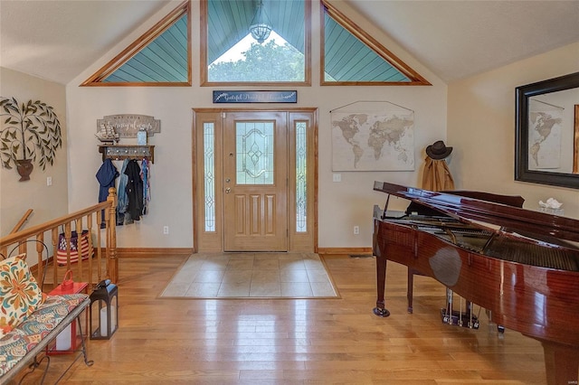 entryway with vaulted ceiling and light hardwood / wood-style floors