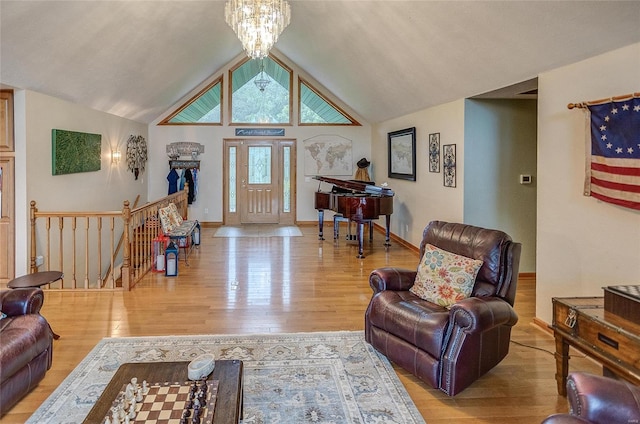 living room with a notable chandelier, vaulted ceiling, and hardwood / wood-style flooring