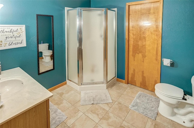 bathroom featuring toilet, tile patterned floors, vanity, and an enclosed shower