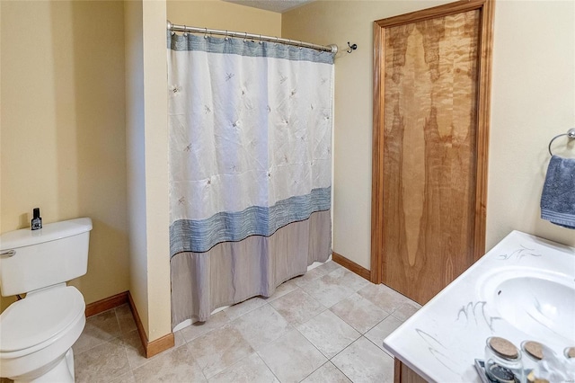 bathroom with vanity, tile patterned flooring, and toilet