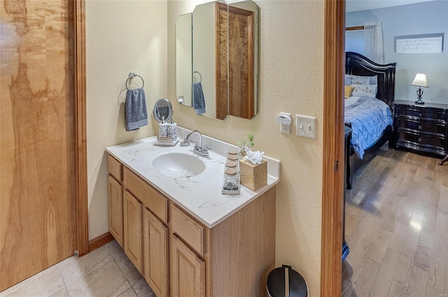 bathroom with vanity and wood-type flooring