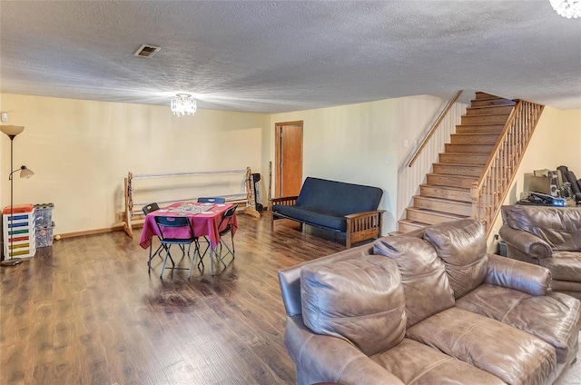 living room featuring dark hardwood / wood-style flooring and a textured ceiling