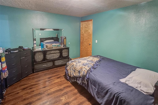 bedroom with a textured ceiling and hardwood / wood-style floors