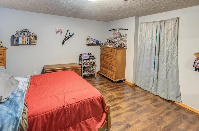 bedroom with dark hardwood / wood-style flooring and a textured ceiling