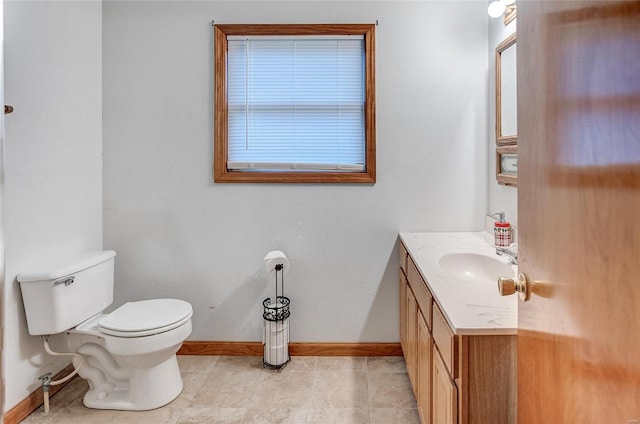 bathroom featuring toilet, vanity, and tile patterned flooring